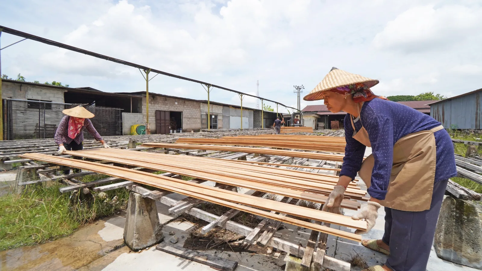Craftspeople sorting and arranging timber during the preparation process